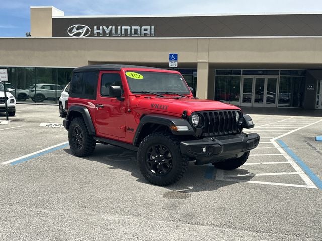 2022 Jeep Wrangler Willys Wheeler in Firecracker Red Clearcoat — front three-quarter view